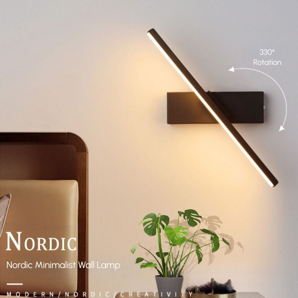 Nordic minimalist rotating LED bedside wall lamp mounted beside bed, white matte finish